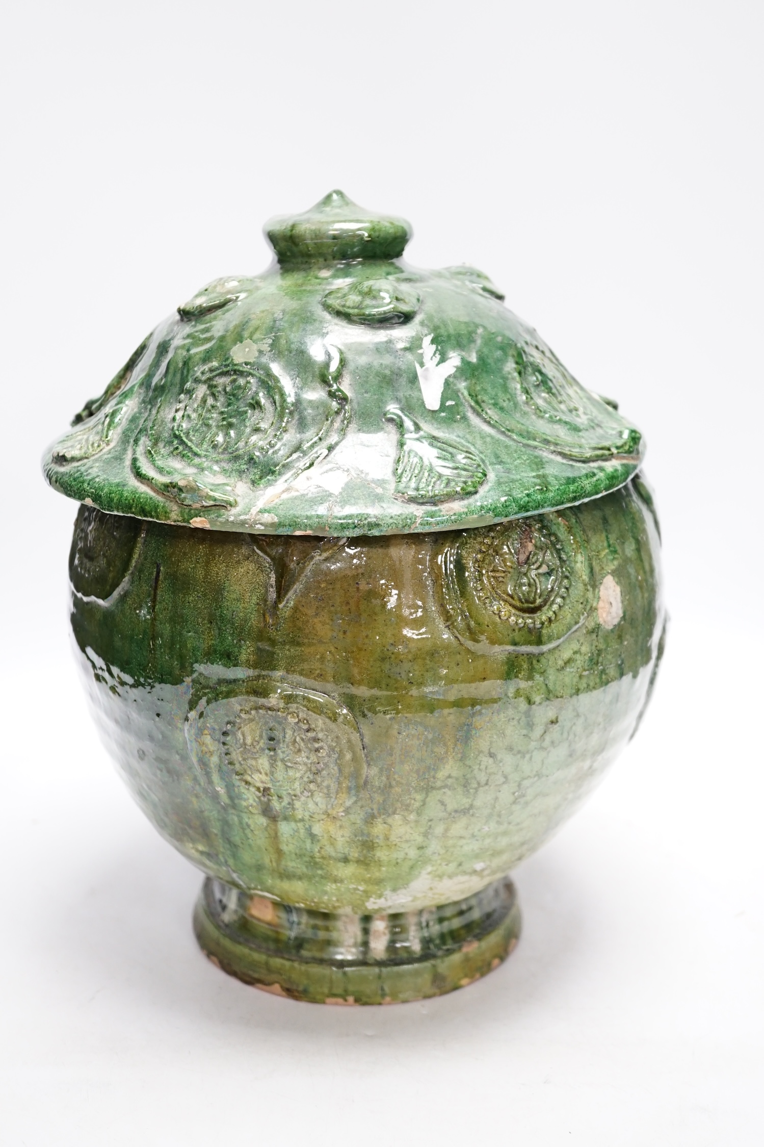 A Chinese Buddhist green glazed jar and cover, Song-Yuan dynasty, 33cm